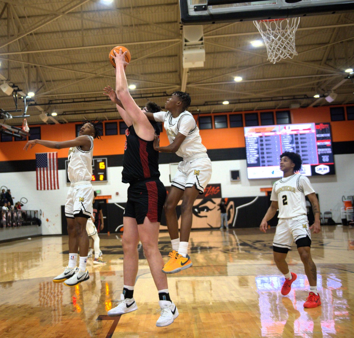 Tulsa Union 7-foot-2 center Erik Madrid grabs a ball down low during a Redhawks game at the recent Putnam City Invitational.